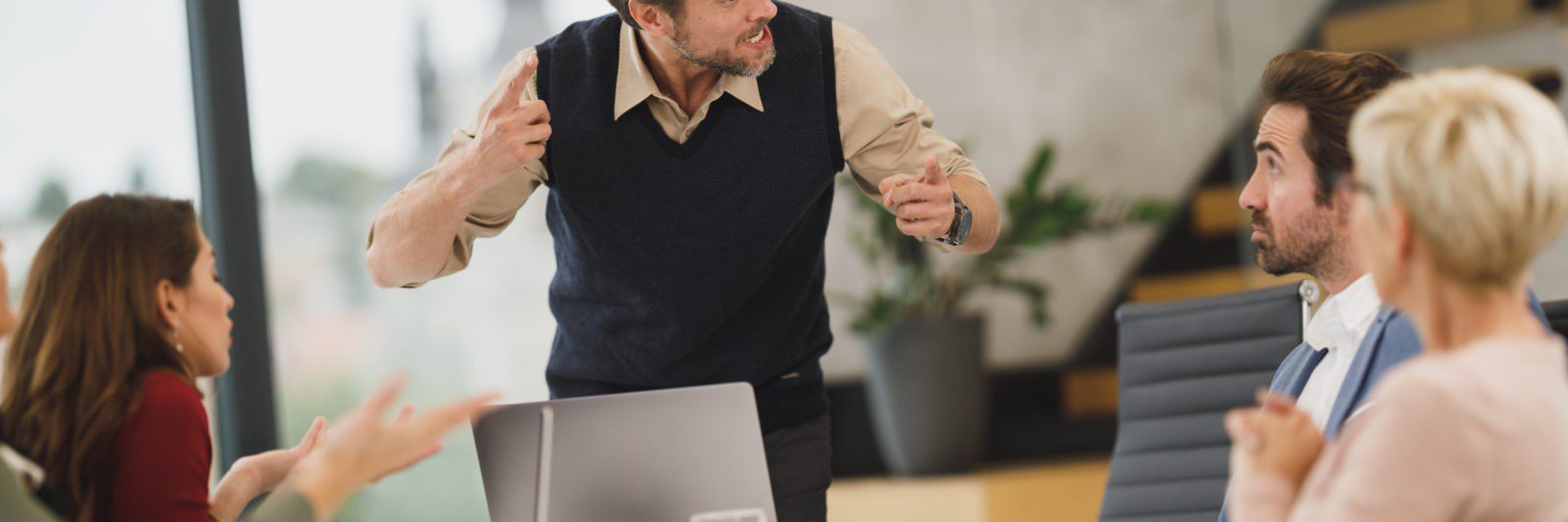 Man gesticulating passionately in a meeting